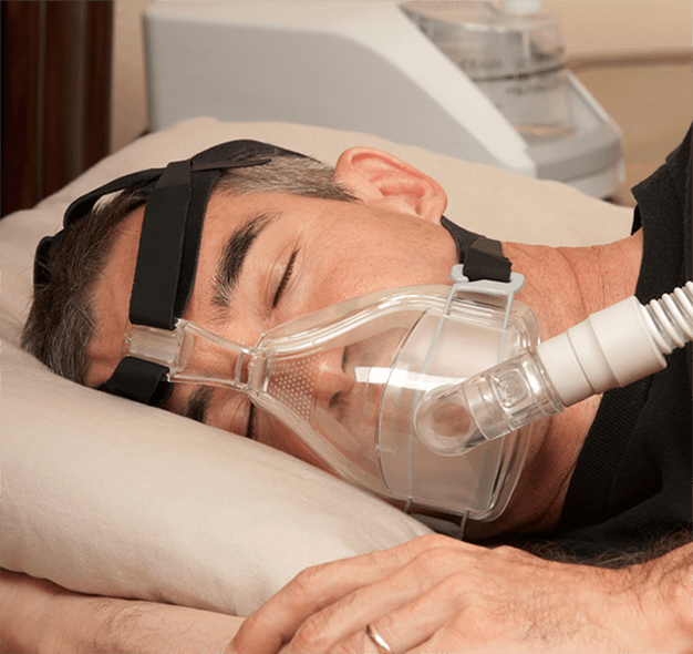 man sleeping with cpap mask
