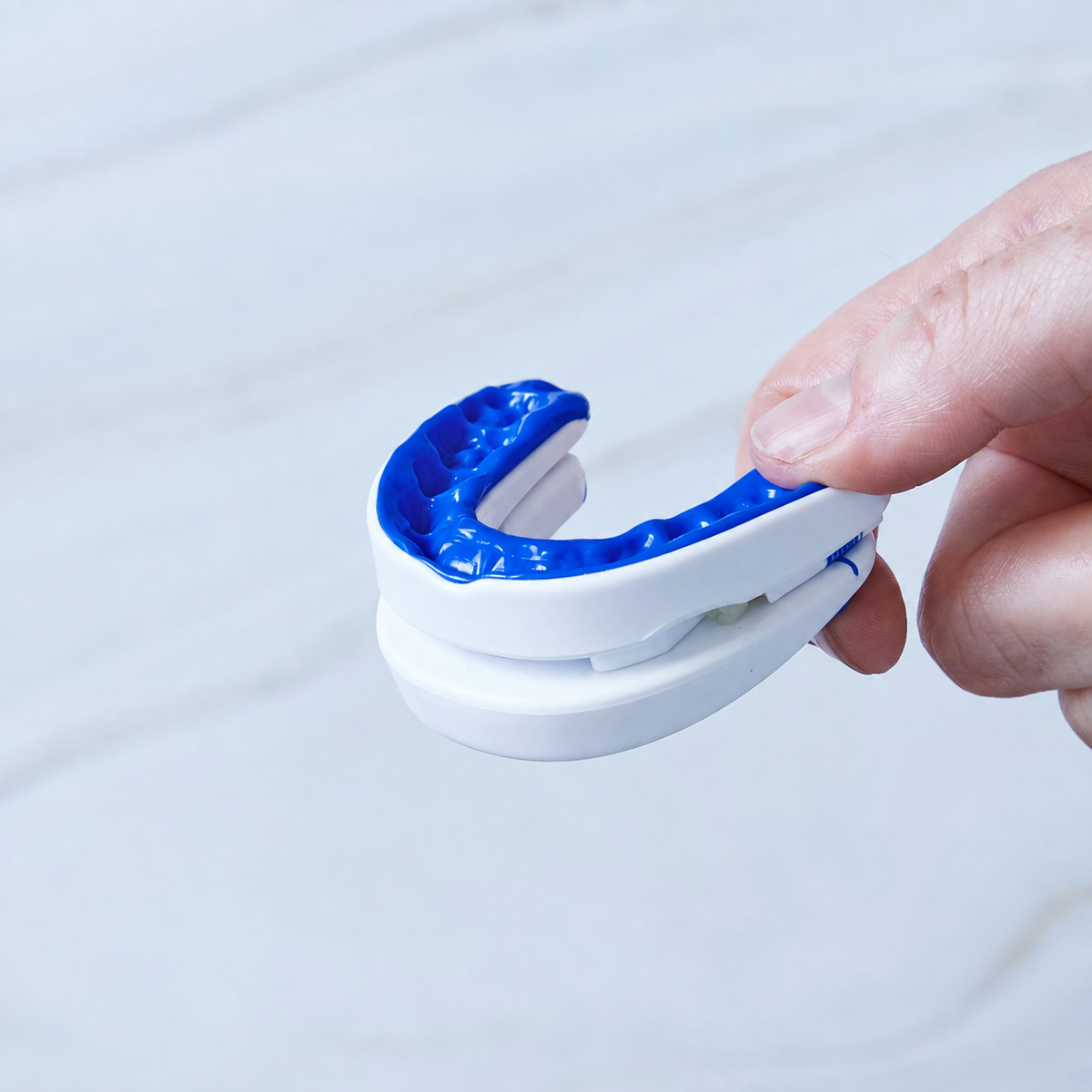 Adjustable anti-snoring mouthpiece resting in its storage case
