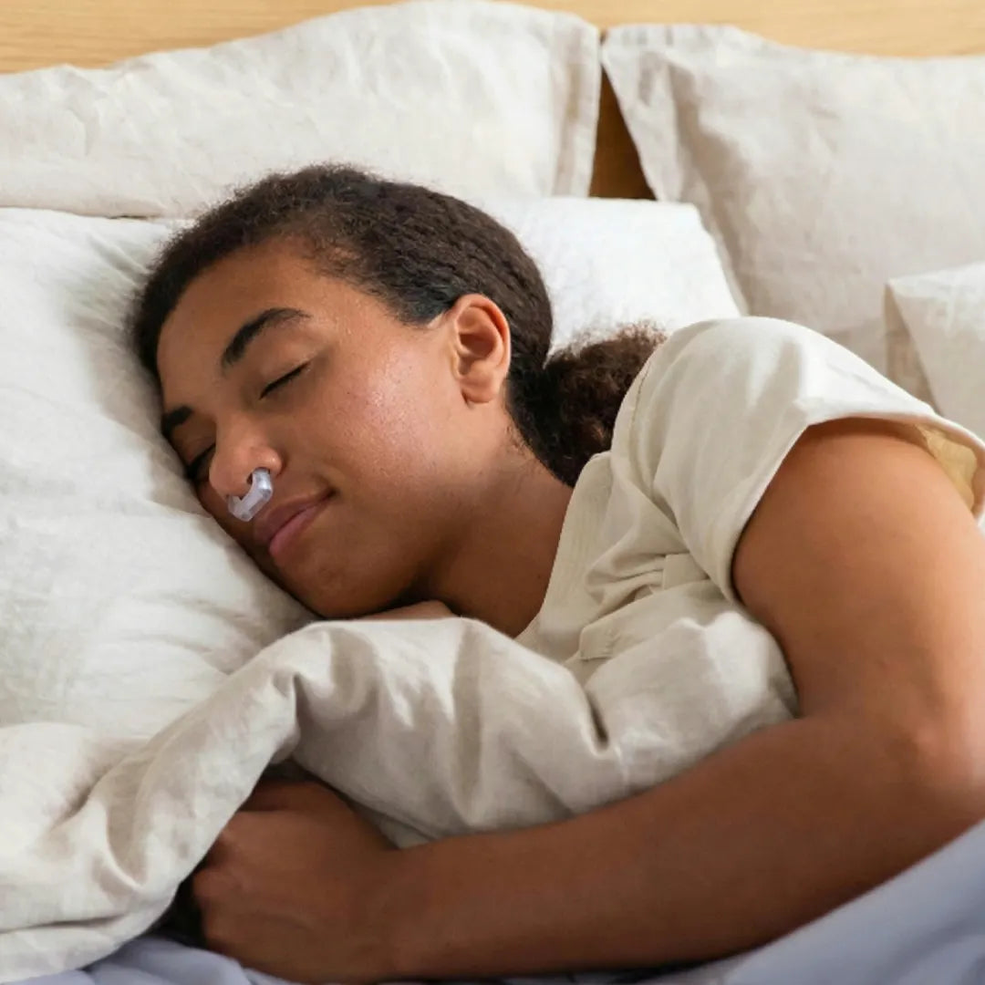 female with nasal strips in bed
