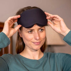 woman wearing black out sleep mask